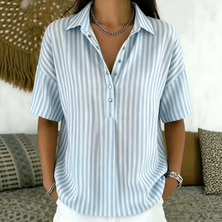 Fashionable women's half-button blouse in a vertical stripe pattern, perfect for spring/summer style.
