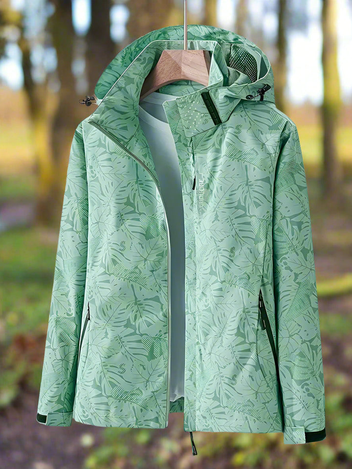 Women's stylish waterproof summer jacket with vibrant green leaf print, perfect for rain and outdoor activities.