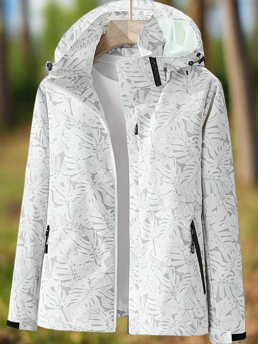 Adjustable women's rain jacket. Stylish leaf print, waterproof for summer adventures, lightweight & comfortable.