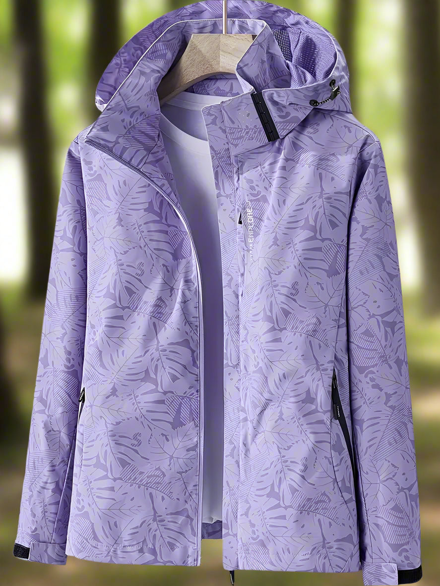 Chic women's waterproof summer jacket featuring an eye-catching leaf print. Stay dry and stylish in any weather.