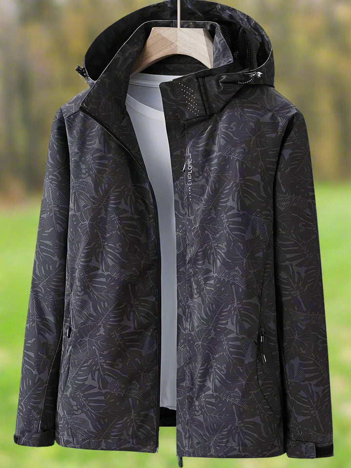 Breathable women's summer rain jacket with elegant leaf print. Lightweight and waterproof for comfortable, stylish outerwear.