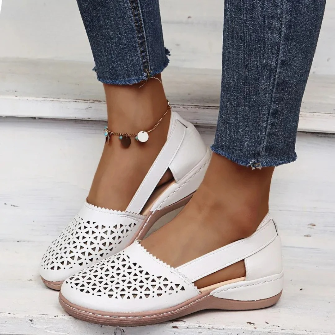 Stylish women's summer flats with orthopedic comfort. Features breathable cutouts & easy slip-on design.