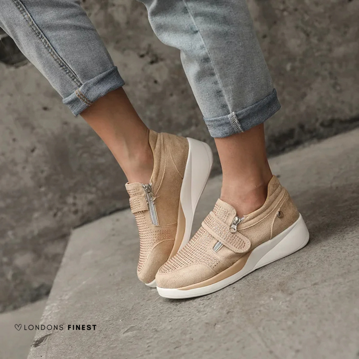 Women's supportive sneakers with cushioned insoles, offering arch support for everyday walking comfort.