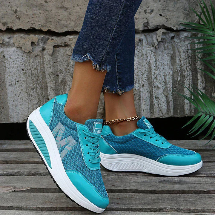 Athletic women's sneakers for walking, featuring breathable fabric & supportive cushioning.