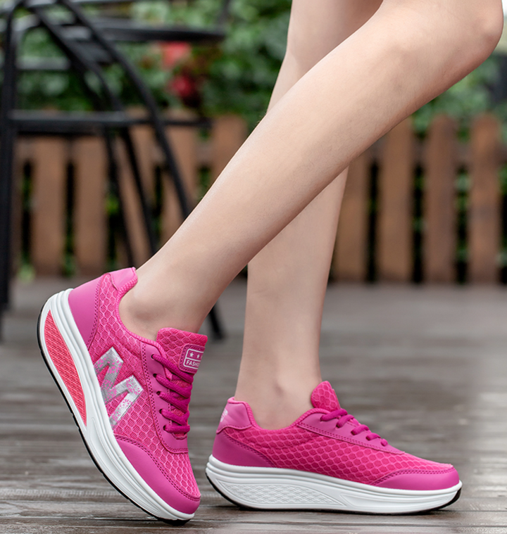 Breathable women's sneakers, offering comfortable and supportive fit for walking.