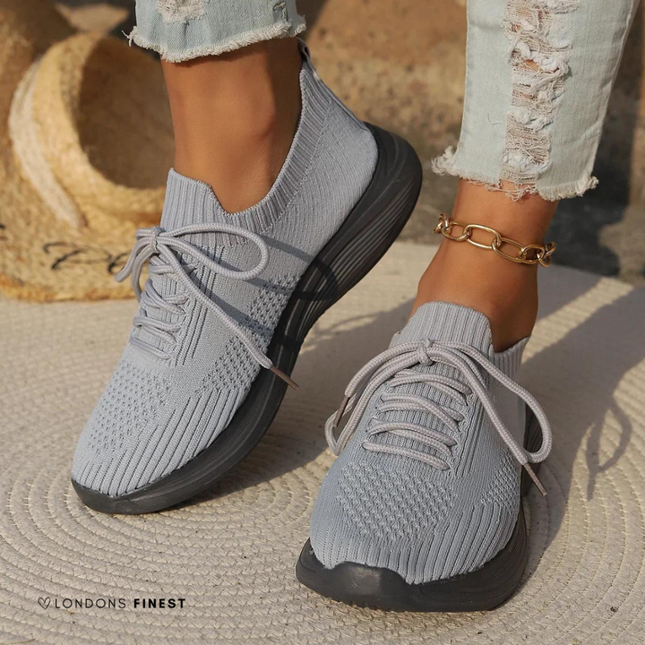 White women's supportive sneakers with ergonomic design for breathable comfort. Ideal lightweight athletic walking shoes.