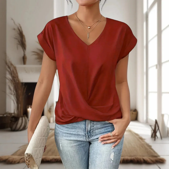 Back view of a comfortable women's solid color short sleeve top, featuring a versatile casual fit.