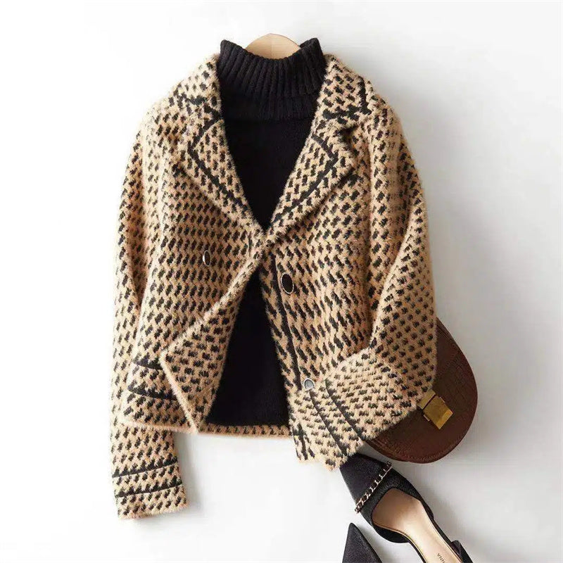 White houndstooth women's jacket, structured and perfect for professional outfits.