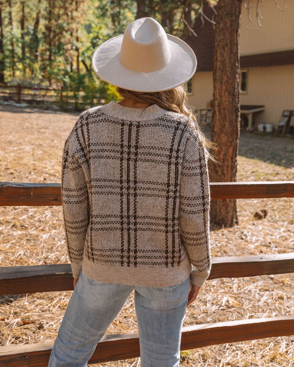 Sleek tailored plaid vest for women, featuring a stylish button-front design for elegant outerwear.