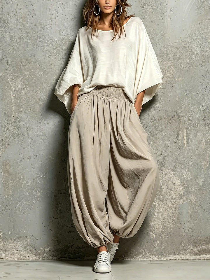 Women's taupe high waist harem pants with a wide, flowing leg for comfortable, casual style. Perfect for boho looks.