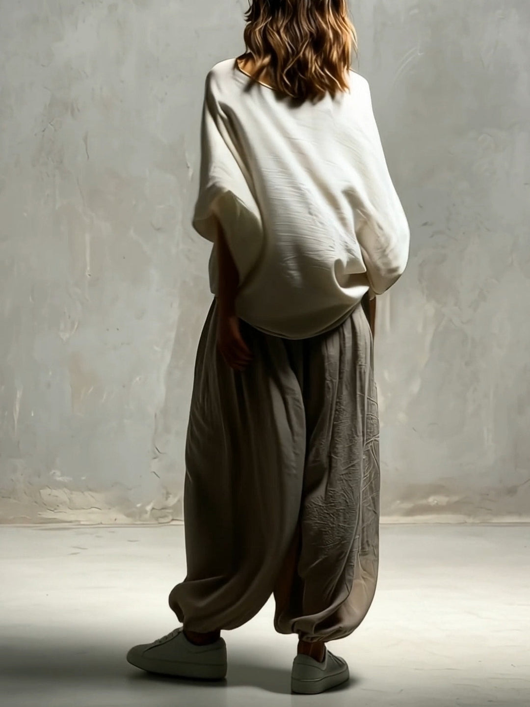 Taupe high waist wide leg harem pants for women, featuring a drawstring waist & relaxed, flowing fit. Ideal for travel.