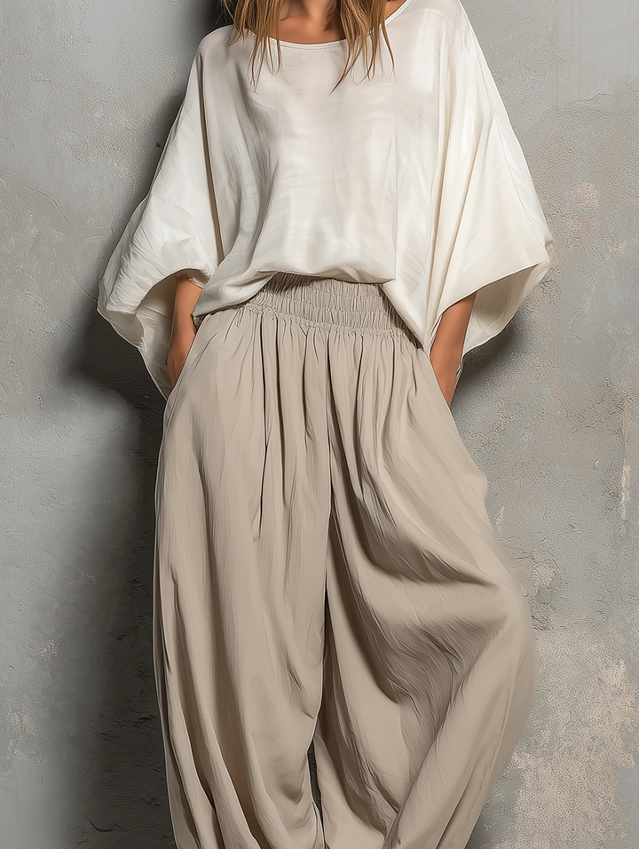 Flowing women's taupe high waist harem pants with a wide leg. Comfortable & stylish, embodying a relaxed boho vibe.