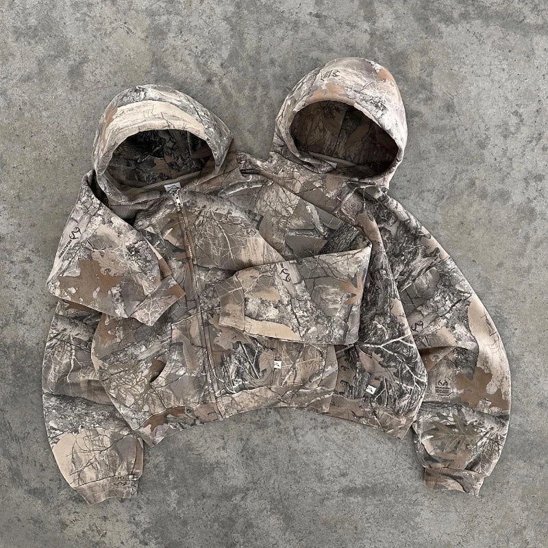 Soft women's camouflage sweater in terrain pattern, ideal for comfortable outdoor wear or a casual urban look.