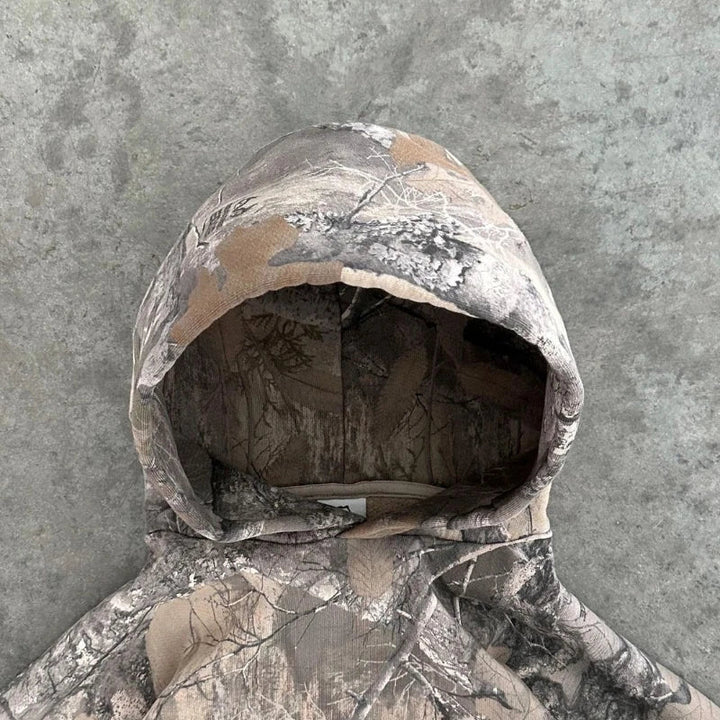 Stylish women's terrain camo hoodie, versatile for outdoor adventures, casual wear, or urban fashion.