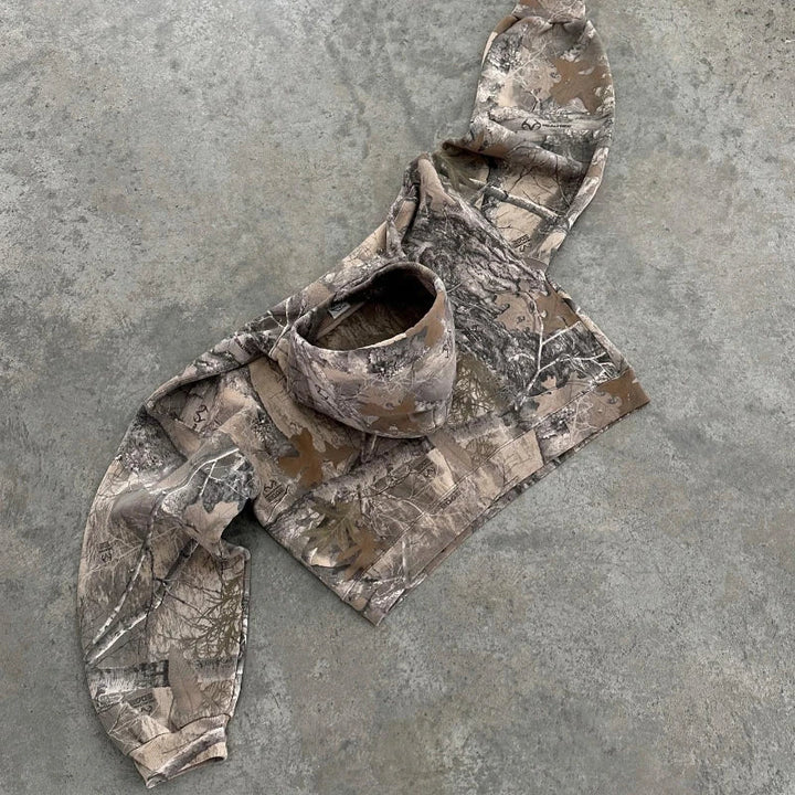 Women's full-zip terrain camo hoodie, a warm and trendy camouflage sweater, great for layering or standalone style.