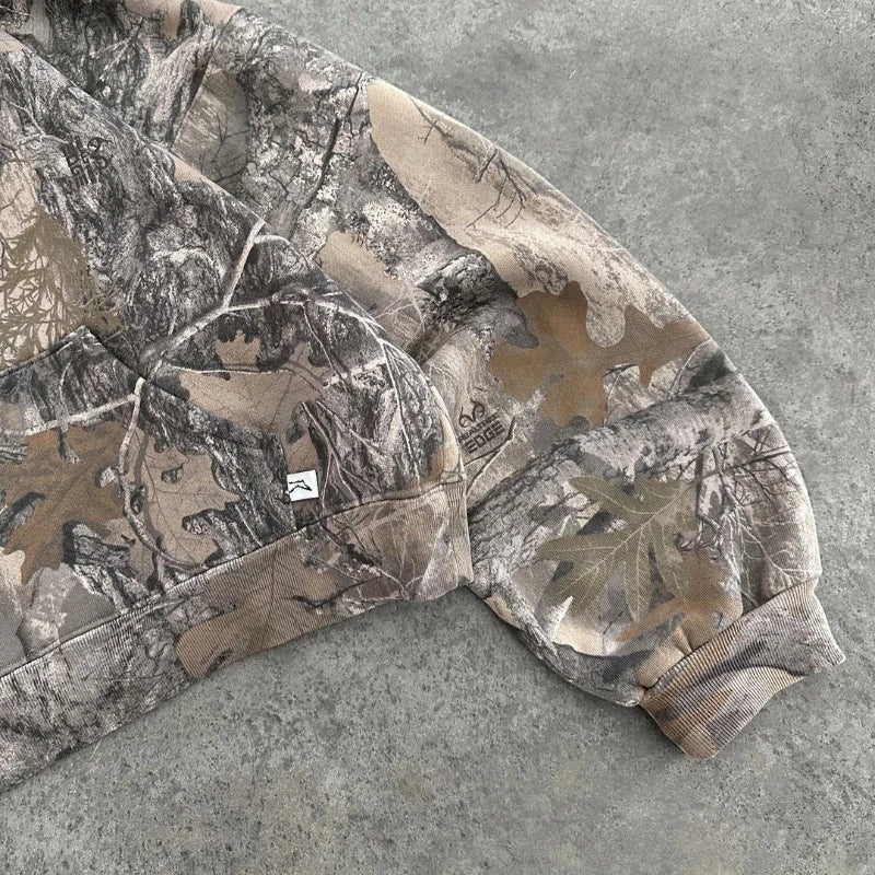 Comfortable women's camouflage hoodie featuring a terrain pattern, excellent for rugged outdoor or casual urban style.