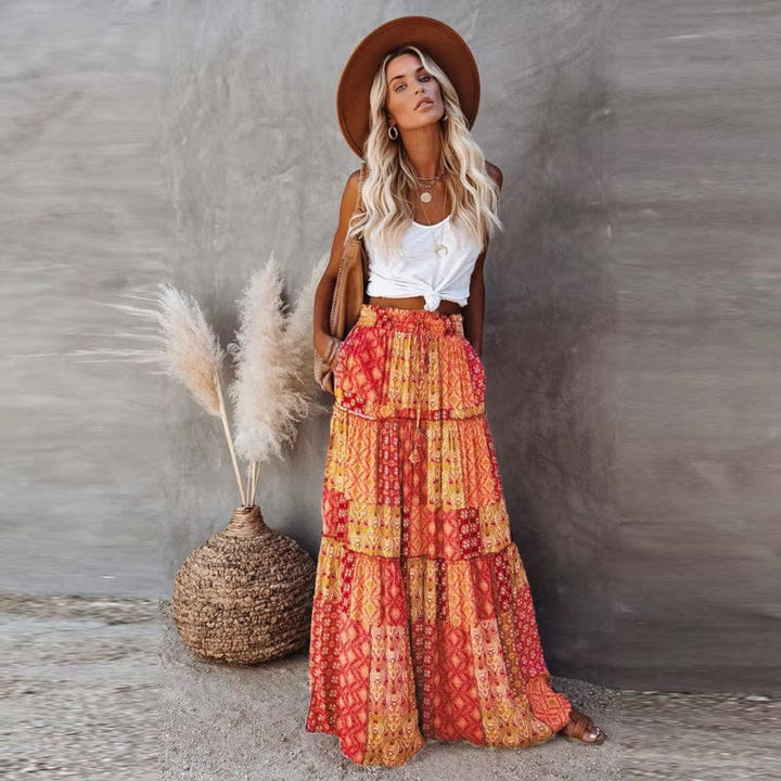 Women's tiered floral maxi skirt with high elastic waist, perfect for summer style.