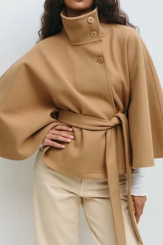 Chic women's fashion cape with elegant self-tie, modern oversized fit. Sophisticated layering.