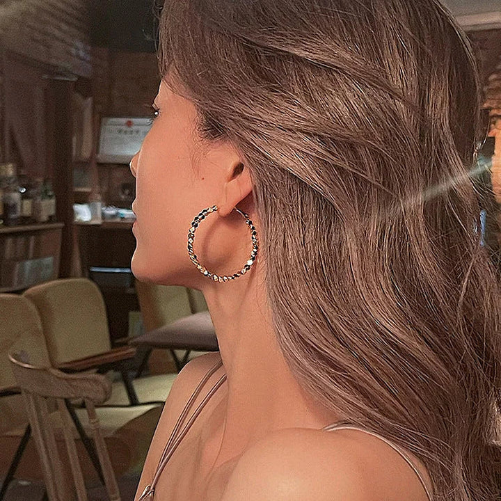 Women's timeless silver faceted hoop earrings for elegant everyday style.