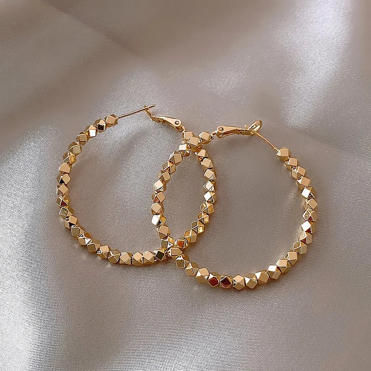 Elegant faceted hoop earrings for women, perfect for timeless everyday wear.