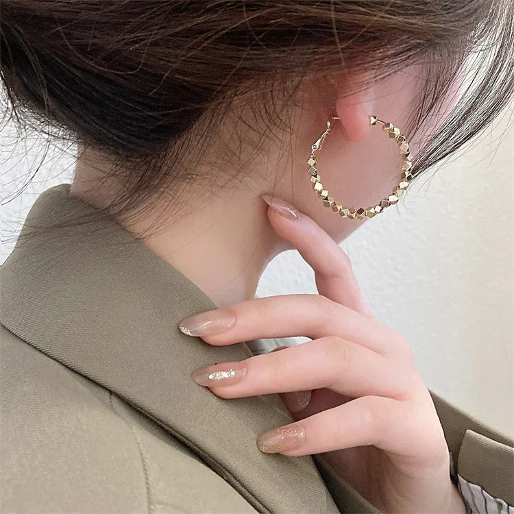 Shimmering silver faceted hoop earrings, an elegant & versatile choice for women's jewelry.