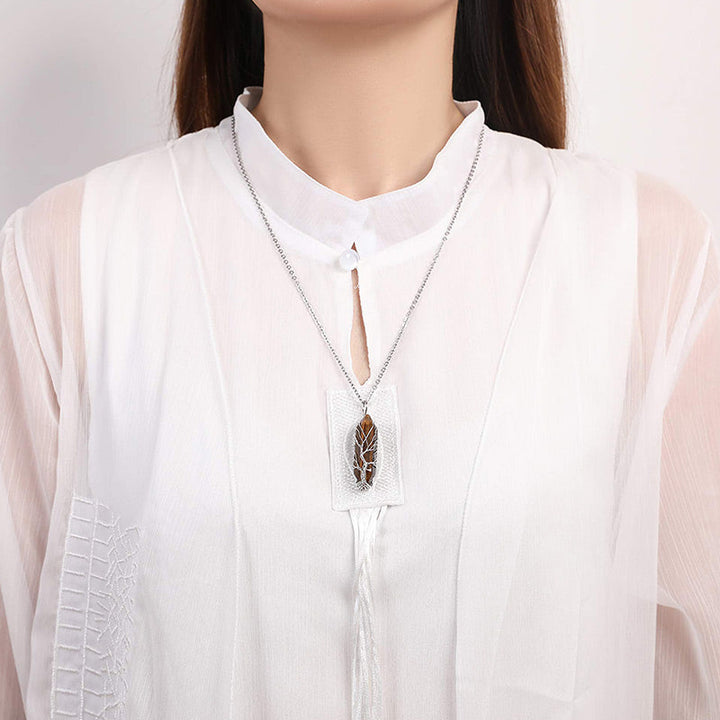 Elegant women's crystal gemstone necklace, Tree of Life motif, spiritual jewelry.