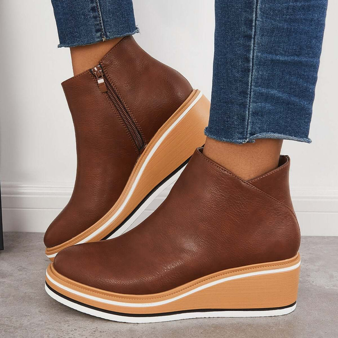 Women's trendy black ankle boots with a prominent zipper & platform sole for fall fashion.
