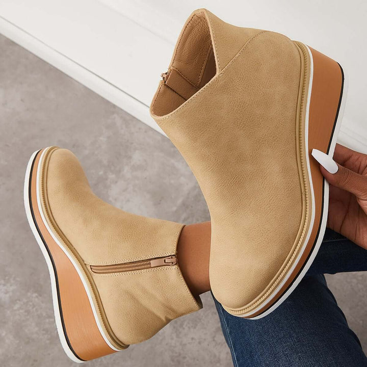 Women's winter ankle boots: fashionable platform design with a secure zipper for warmth.