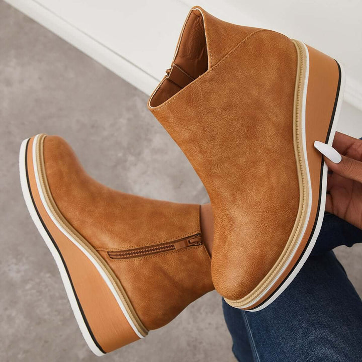 Contemporary women's zipper ankle boots, elevated with a stylish platform sole & trendy look.