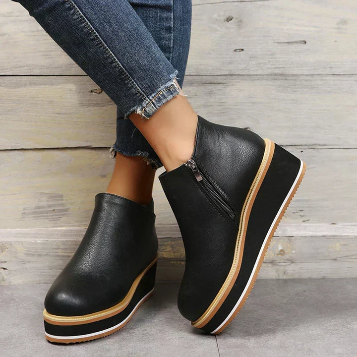 Stylish women's platform ankle boots with a zipper, perfect for a chic fall outfit.