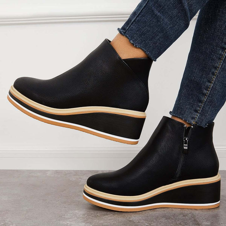 Fashion-forward women's ankle boots, with a trendy platform sole & prominent zipper detail.