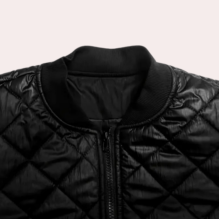 Sleek black women's bomber jacket with a full zip closure & practical pockets, essential trendy outerwear.