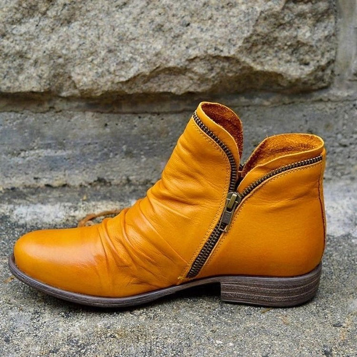 Comfortable women's leather ankle boots, trendy zipper closure, perfect for versatile everyday modern style.