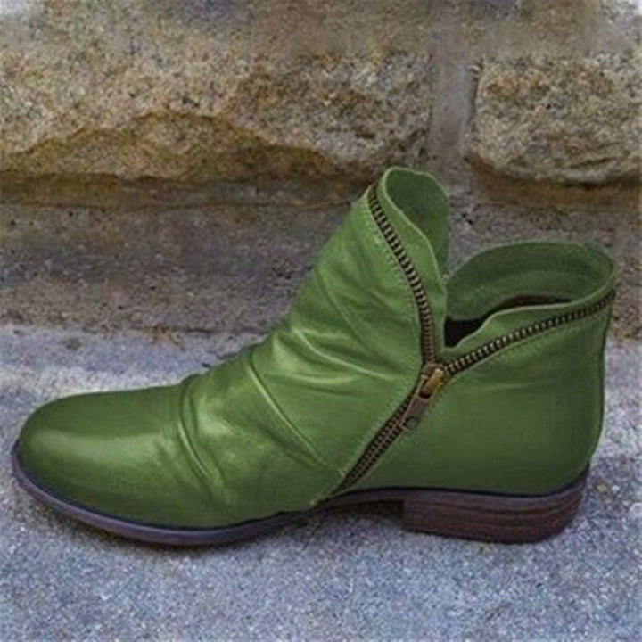 Stylish women's trendy leather ankle boots with sleek design & convenient zipper for comfortable wear.