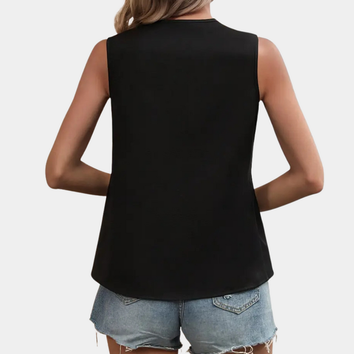 Close-up of the women's asymmetrical blouse, showcasing the unique black & white pattern and flowing fabric.