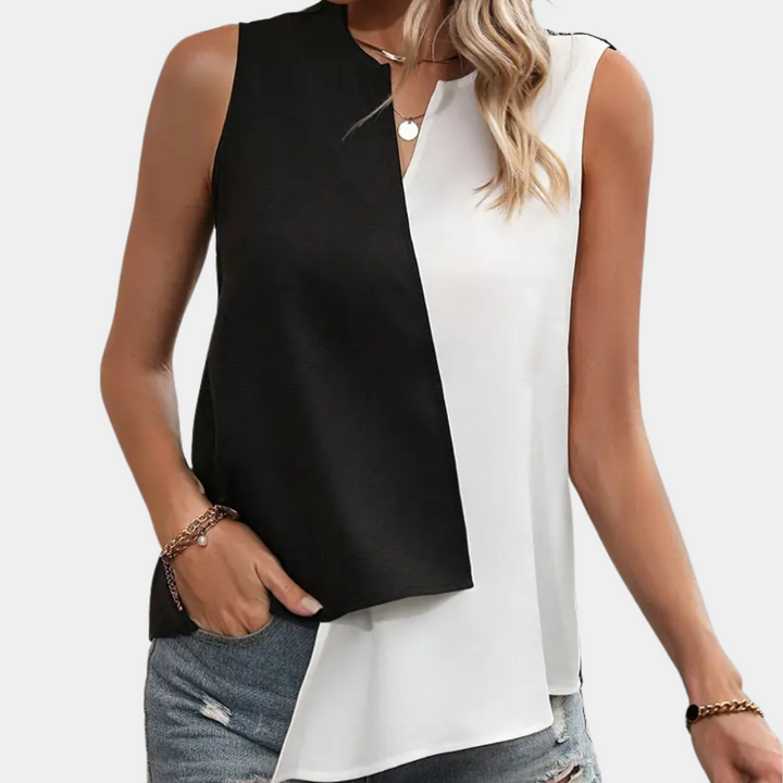 Full view of the women's modern asymmetrical blouse in black and white, highlighting its trendy design.