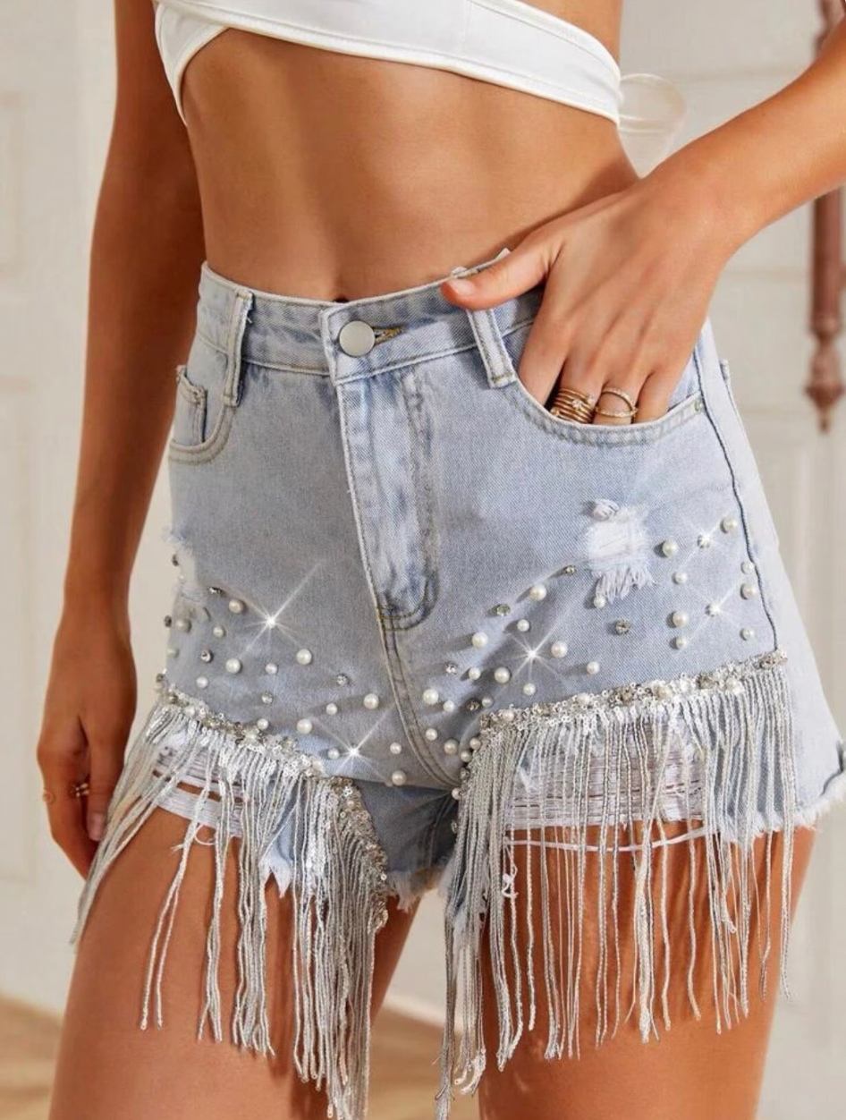 Chic women's denim shorts featuring unique tassel details, ideal for summer fashion and vacation outfits.