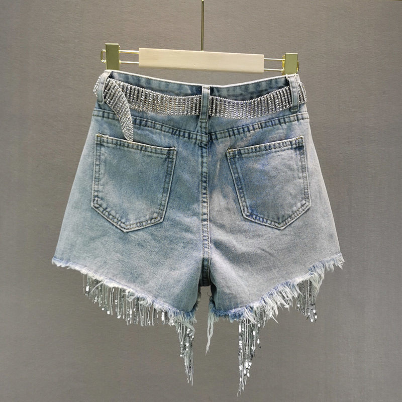 Trendy women's tassel denim shorts in blue, perfect for chic summer style and warm weather outfits.