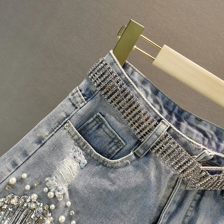 Casual women's blue denim shorts with a trendy tassel hem, a must-have for summer fashion.