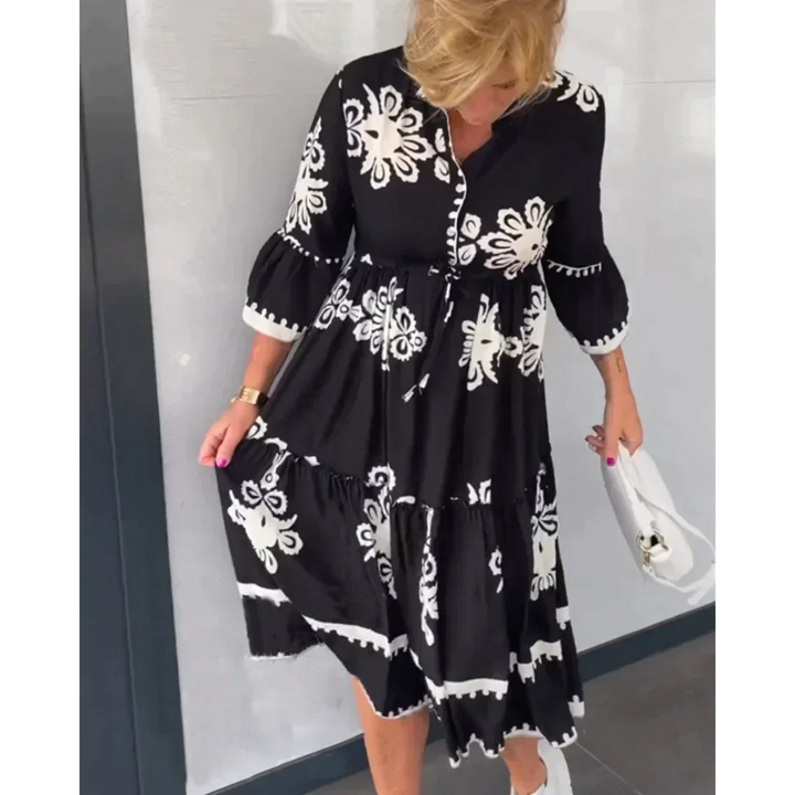 Vibrant floral print women's midi dress with chic 3/4 sleeves, ideal for sunny summer occasions.