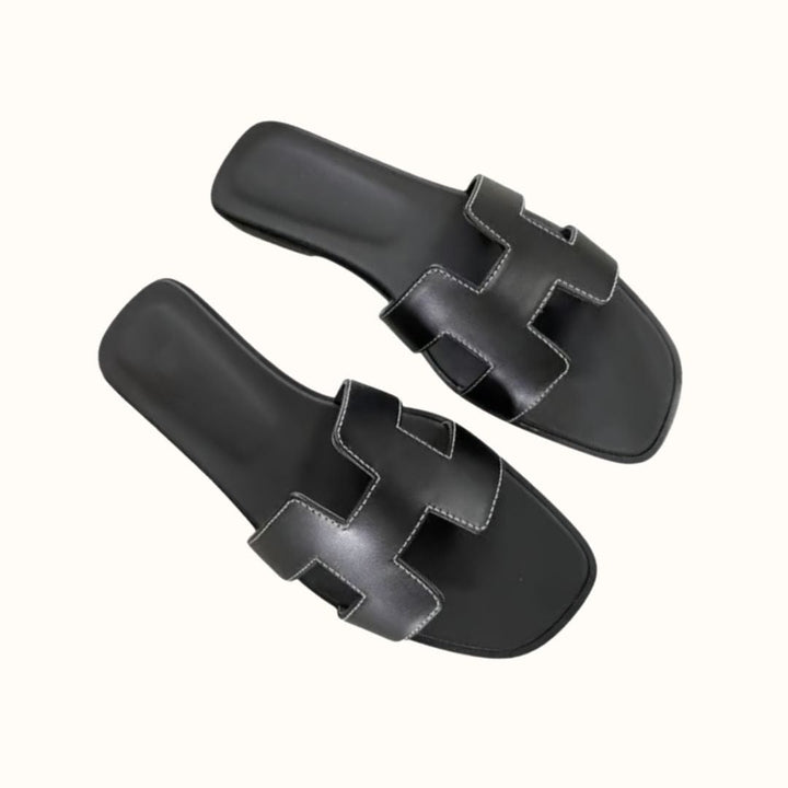Flat H-profile slide sandals for women, trendy and comfortable for stylish casual wear.