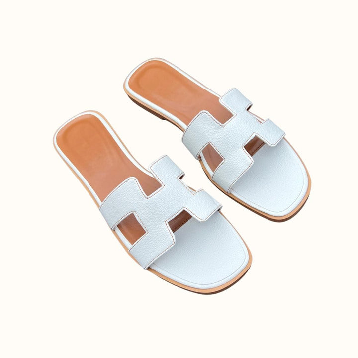 Women's H-profile slide sandals, comfortable, trendy, and chic open-toe summer footwear.