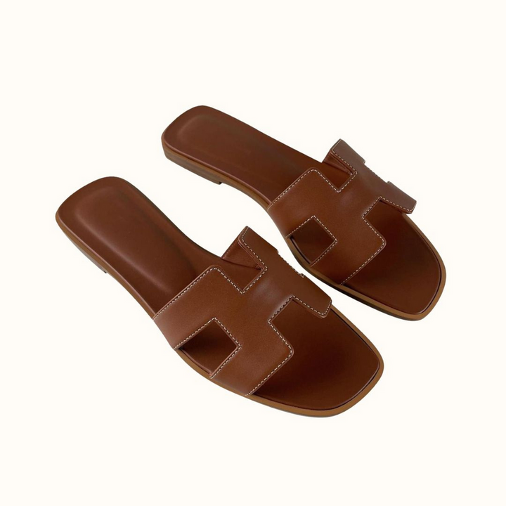 Modern H-profile open-toe slide sandals for women, stylish, flat, and comfortable for summer.