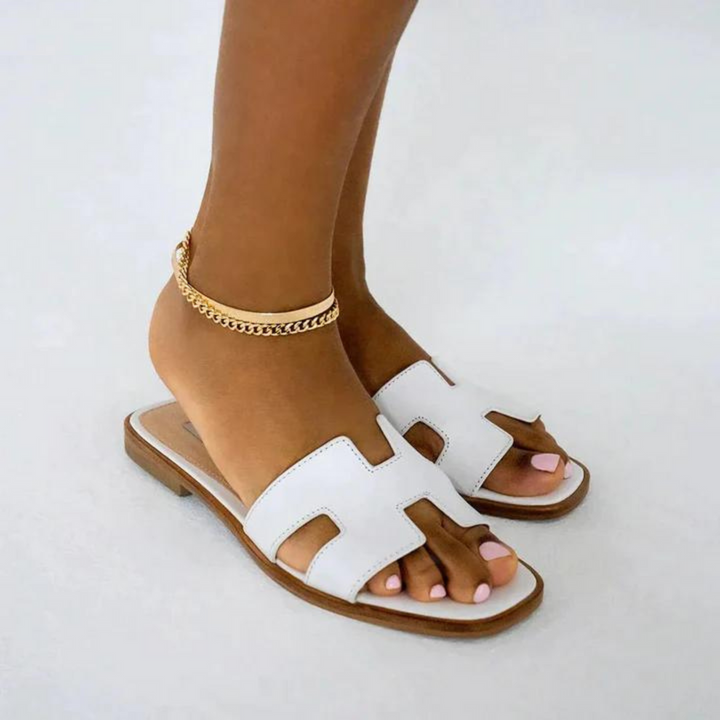 Elegant open-toe H-profile slide sandals for women, flat and fashionable summer footwear.