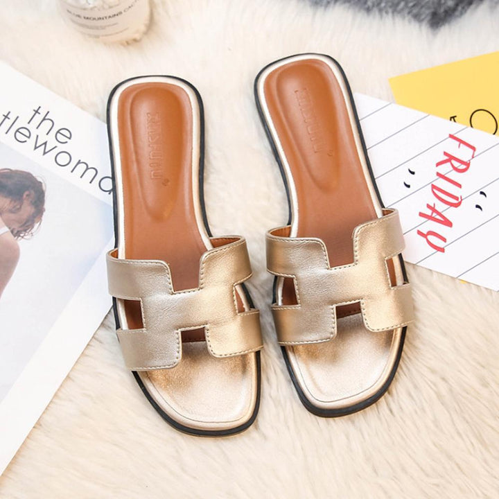 Trendy H-profile slide sandals for women, offering fashion footwear and ultimate comfort.