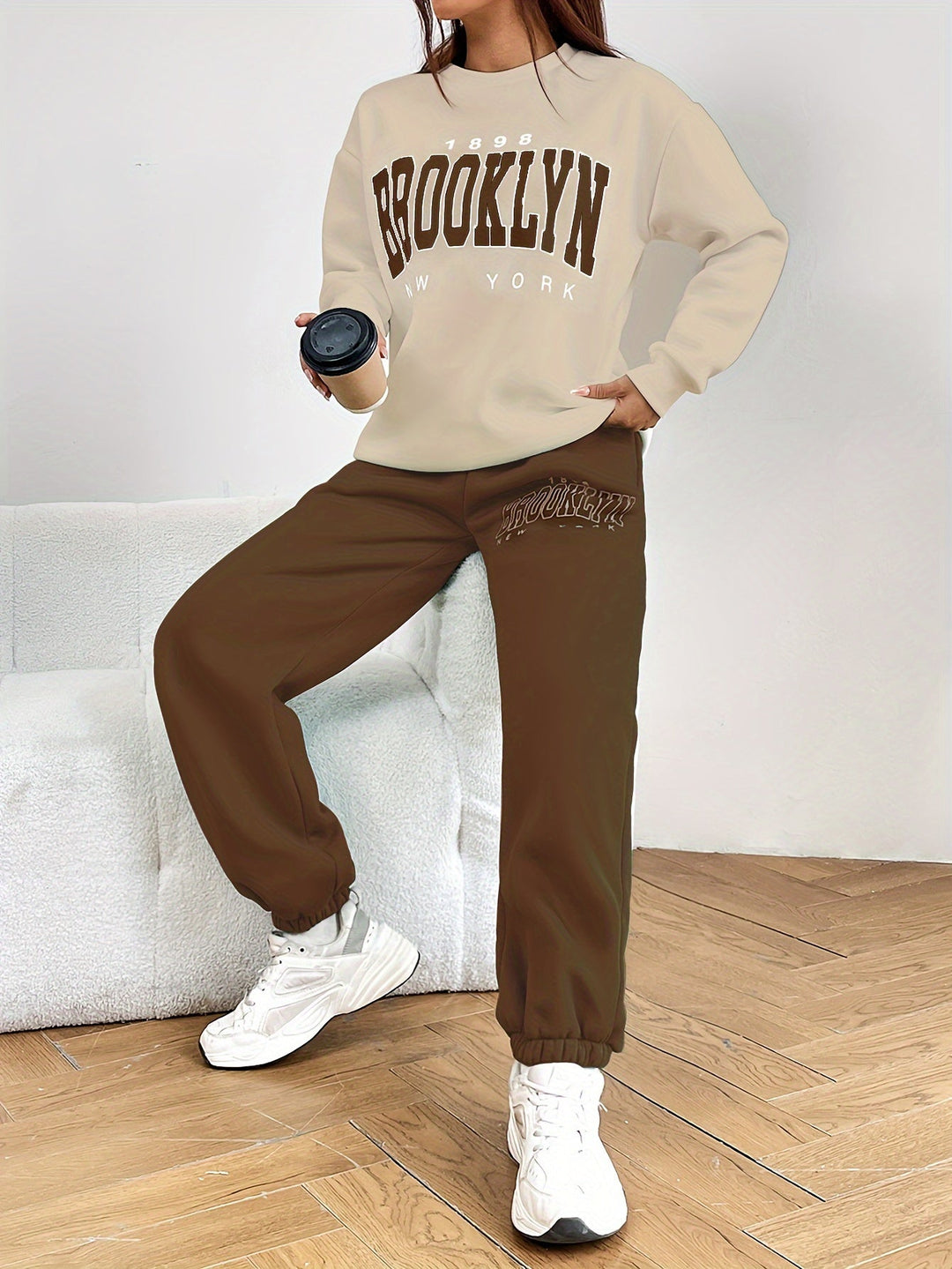 Women's jogging suit featuring a stylish letter print design. A comfortable two-piece set for loungewear.