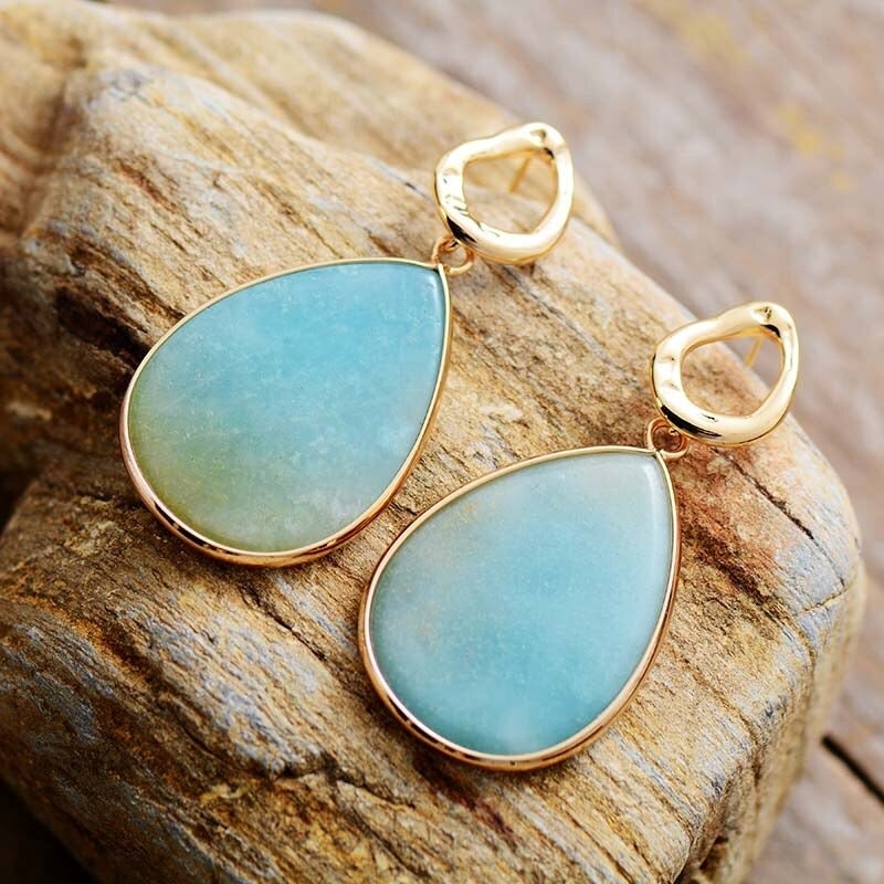 Close-up of women's tropical amazonite dangle earrings, natural gemstone jewelry.