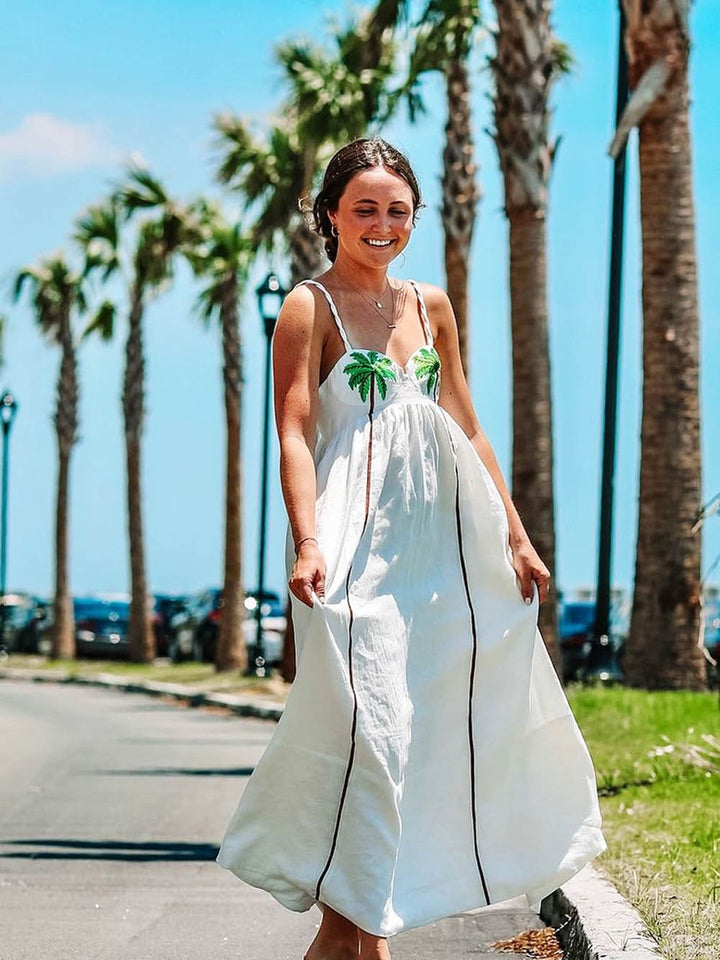 Women's tropical palm print strappy summer dress, Estelle model, perfect for beachwear or casual outings.