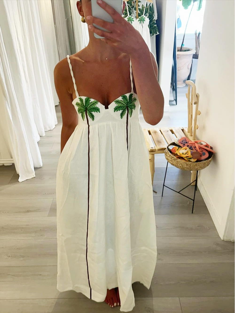 Lightweight women's tropical palm print strappy dress, Estelle, offering a chic and comfortable look for summer.