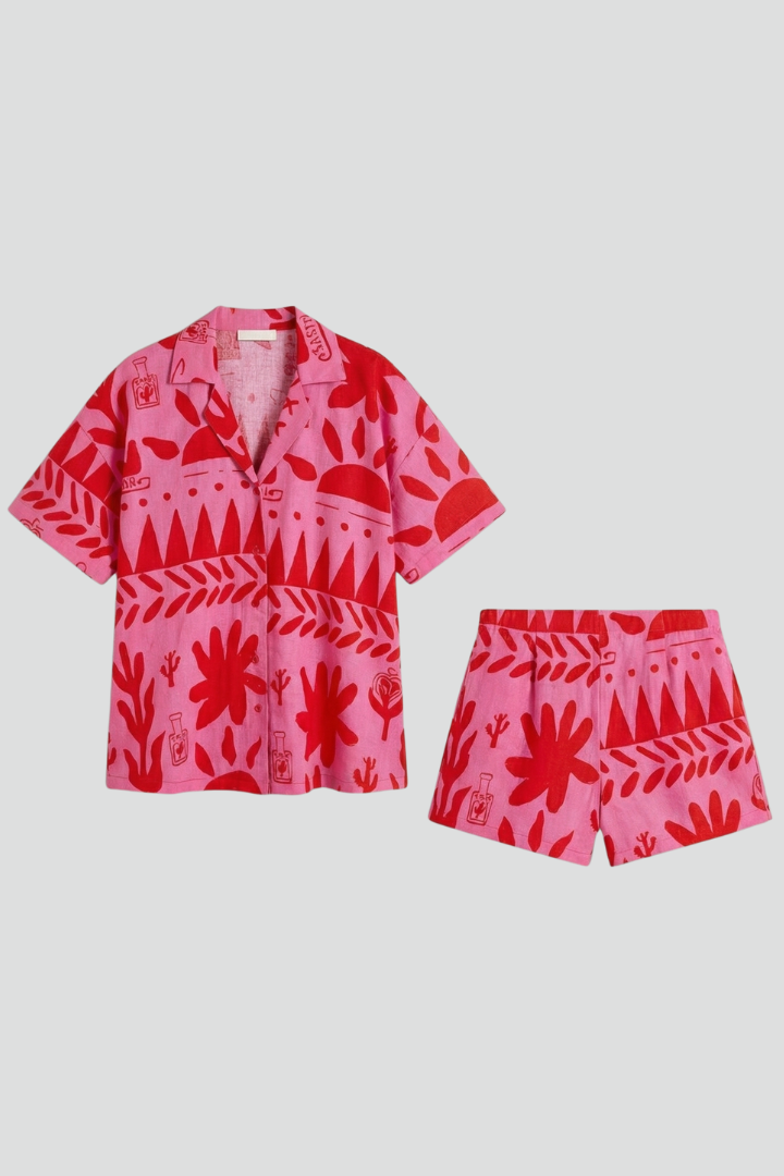 Women's tropical print camp collar shirt & shorts set. Vibrant two-piece summer resort wear, perfect for vacation.
